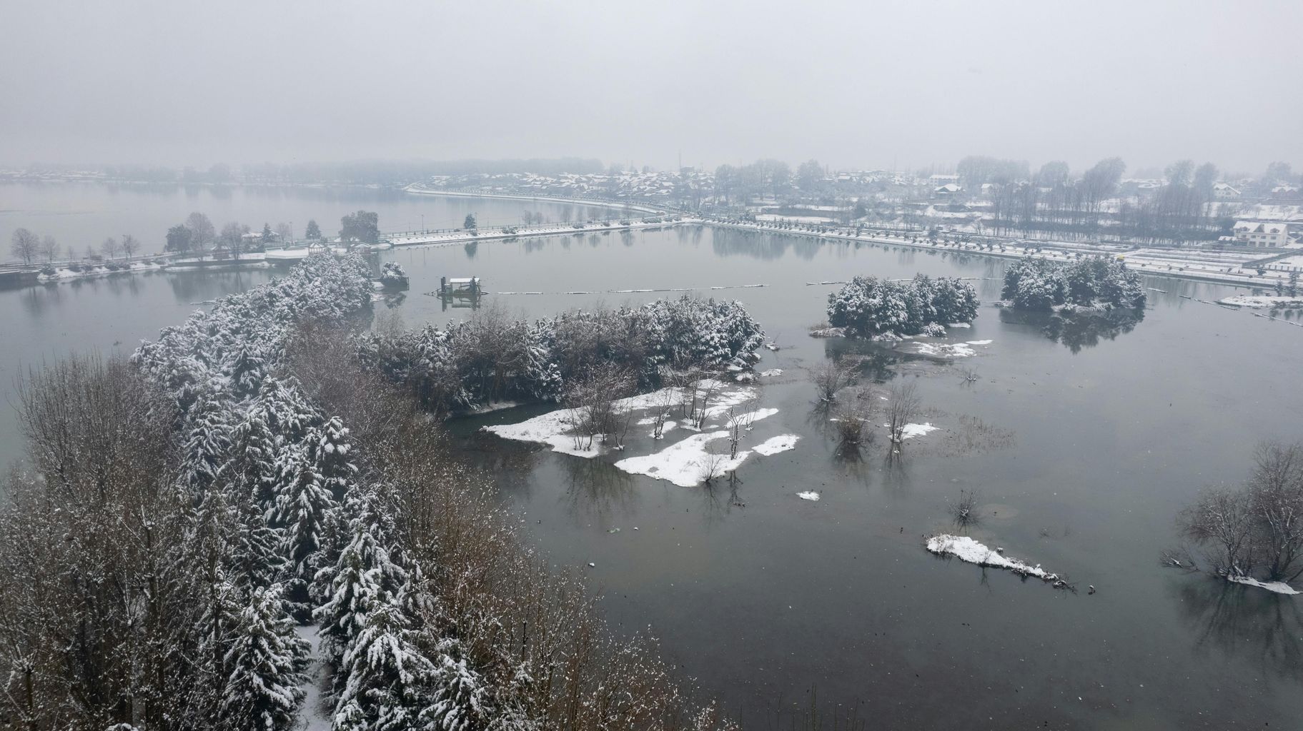 A flooded area in the middle of a snowy field