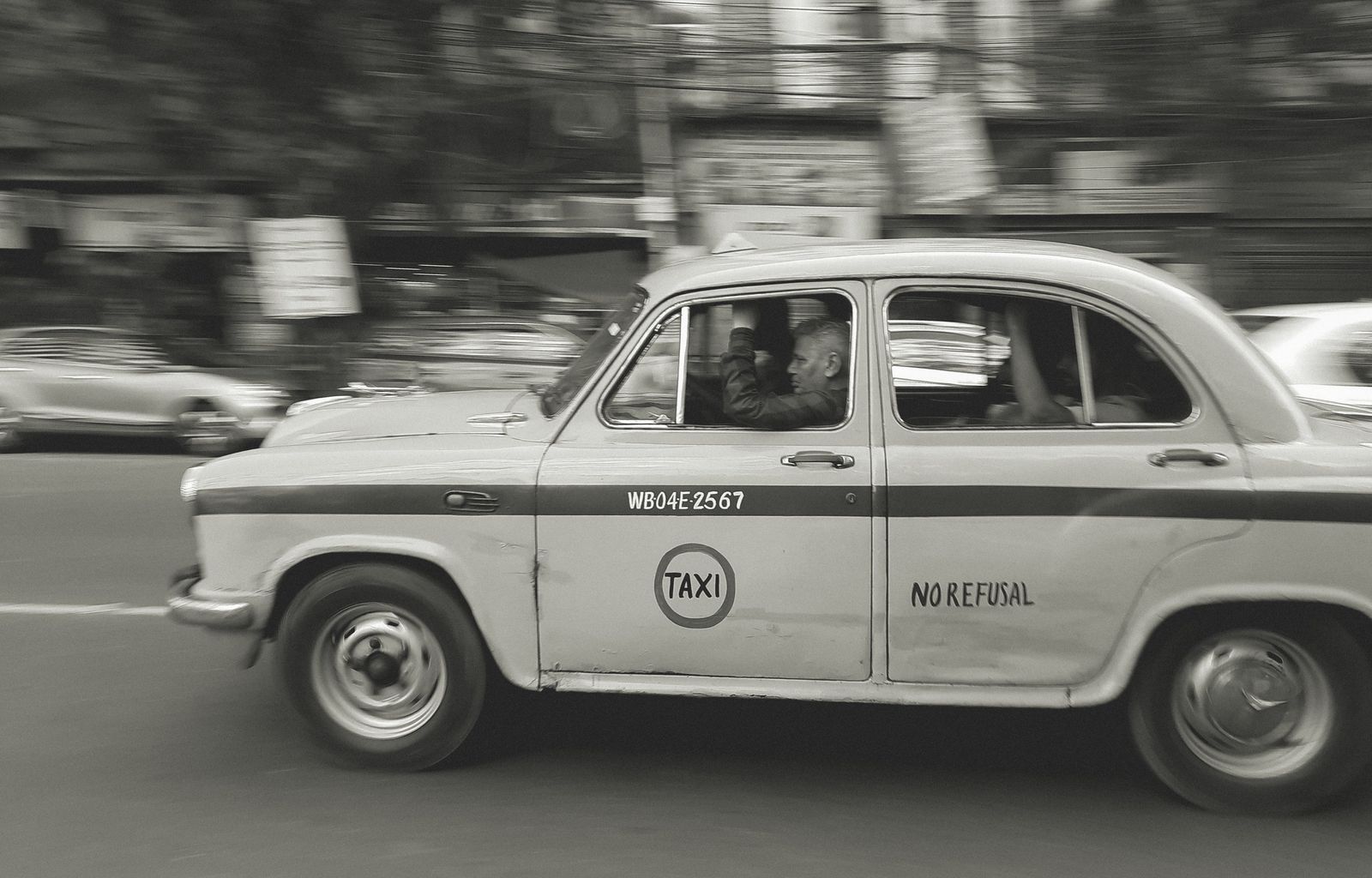 Man Driving Hindustan Ambassador as Taxi