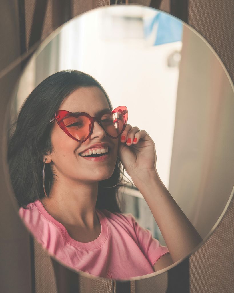 Smiling Woman Wearing Red Sunglasses