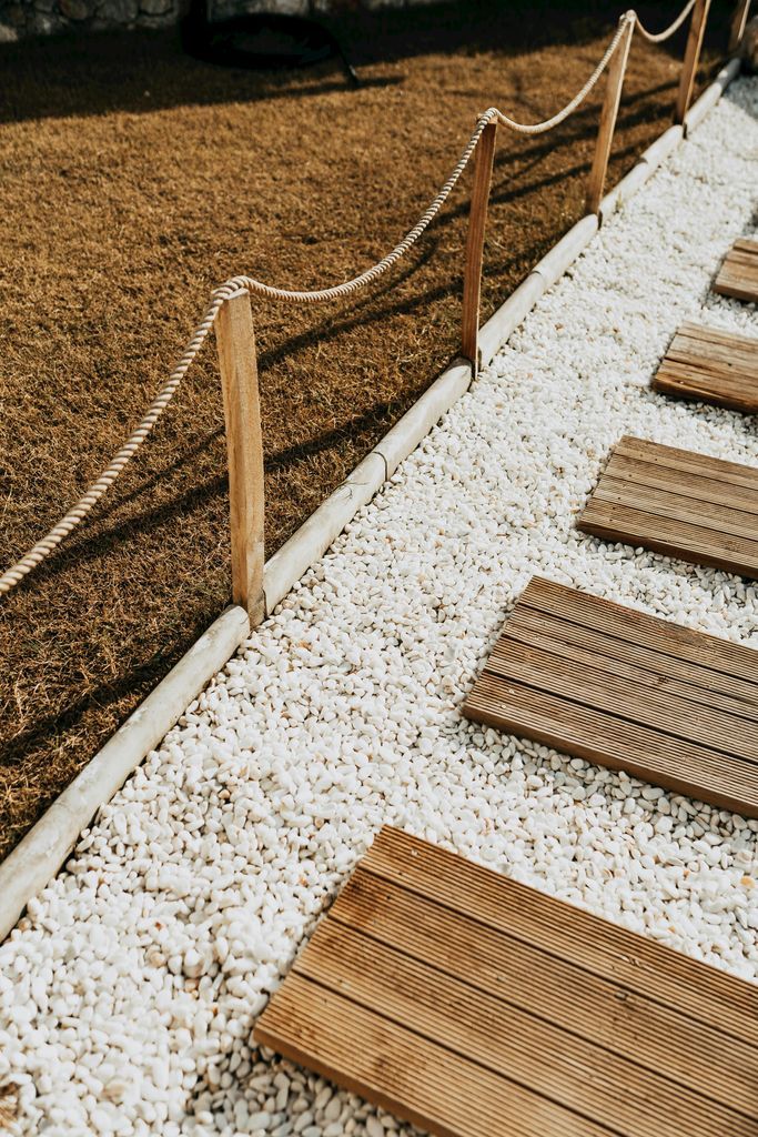 Wooden walkway with rope and gravel