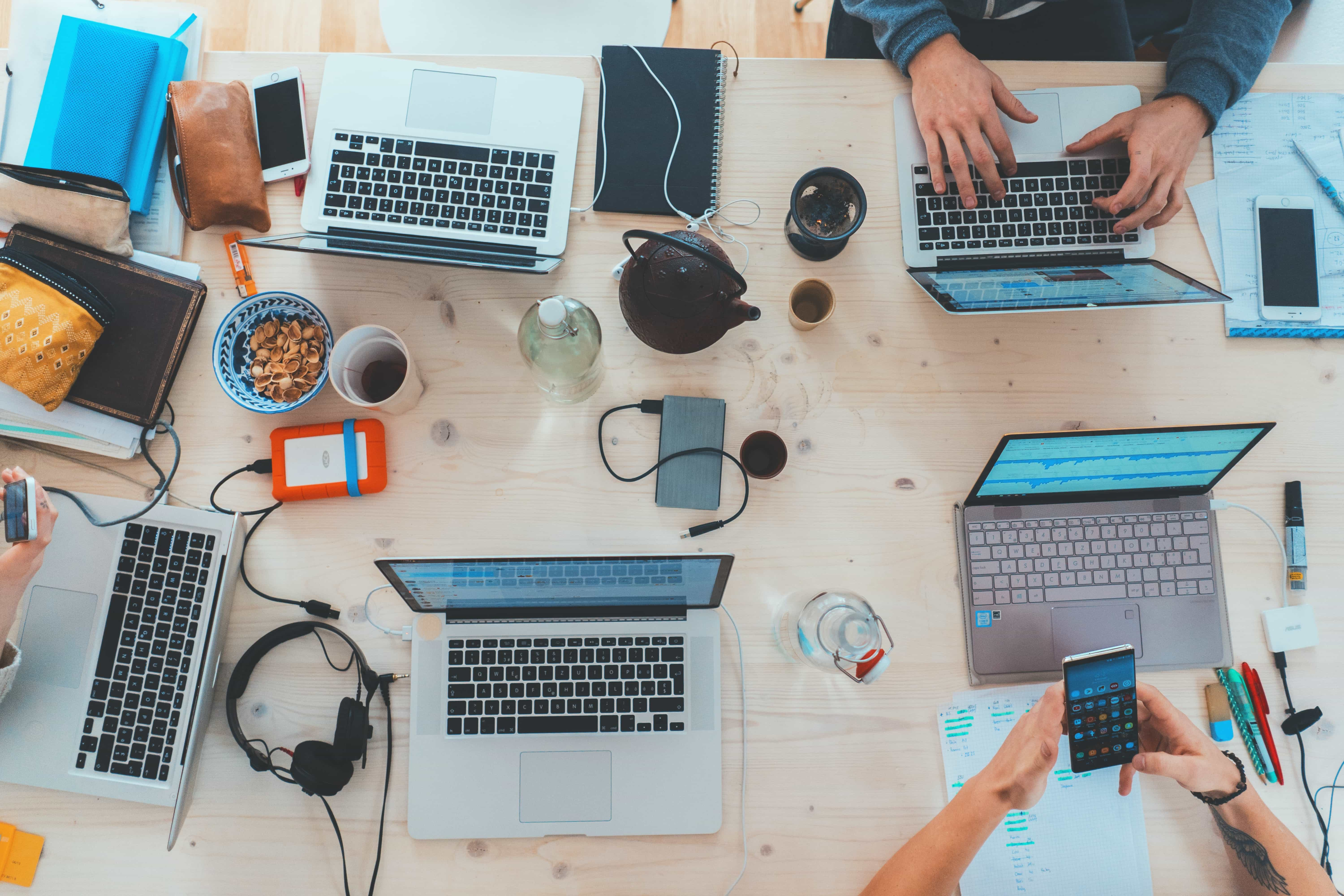 Lots of technological devices crowded on one table