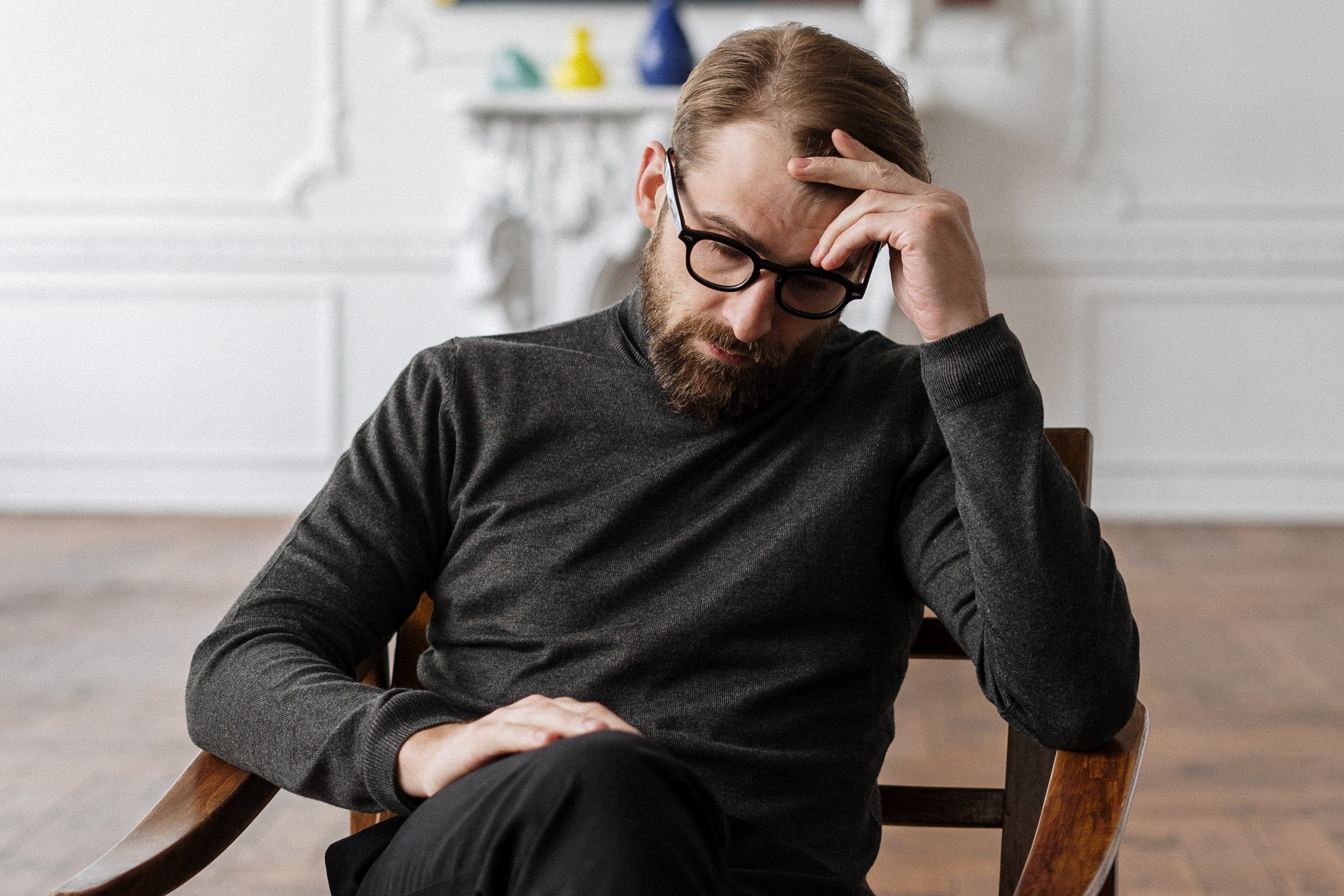 Man sitting on chair stuck in his thoughts